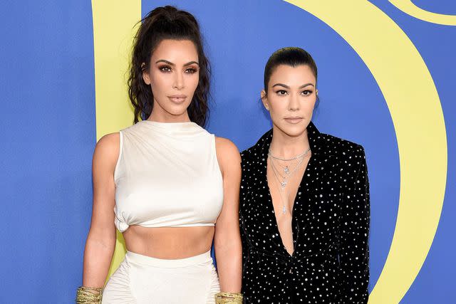 Dimitrios Kambouris/Getty Kim Kardashian (left) and Kourtney Kardashian Barker attend the 2018 CFDA Fashion Awards