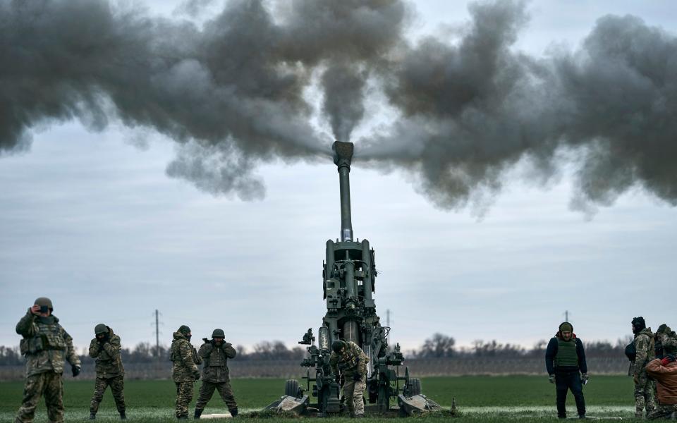 Ukrainian soldiers fire at Russian positions in Kherson - AP Photo/Libkos