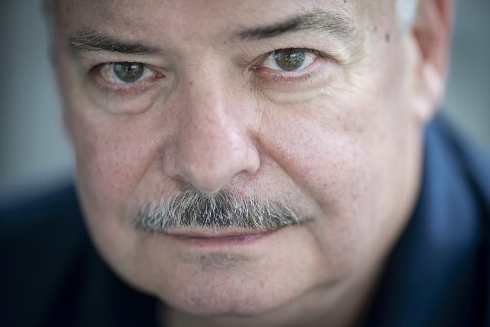 Retired NYPD Officer Mark DeMarco, poses for a portrait in his home in the Staten Island borough of New York on Tuesday, Aug. 3, 2021. For a time after 9/11, He replayed the what-ifs in his mind. If he'd gone right instead of left. A bit earlier. Or later. "I couldn't figure out how I got out of there alive," he says. (AP Photo/Wong Maye-E)