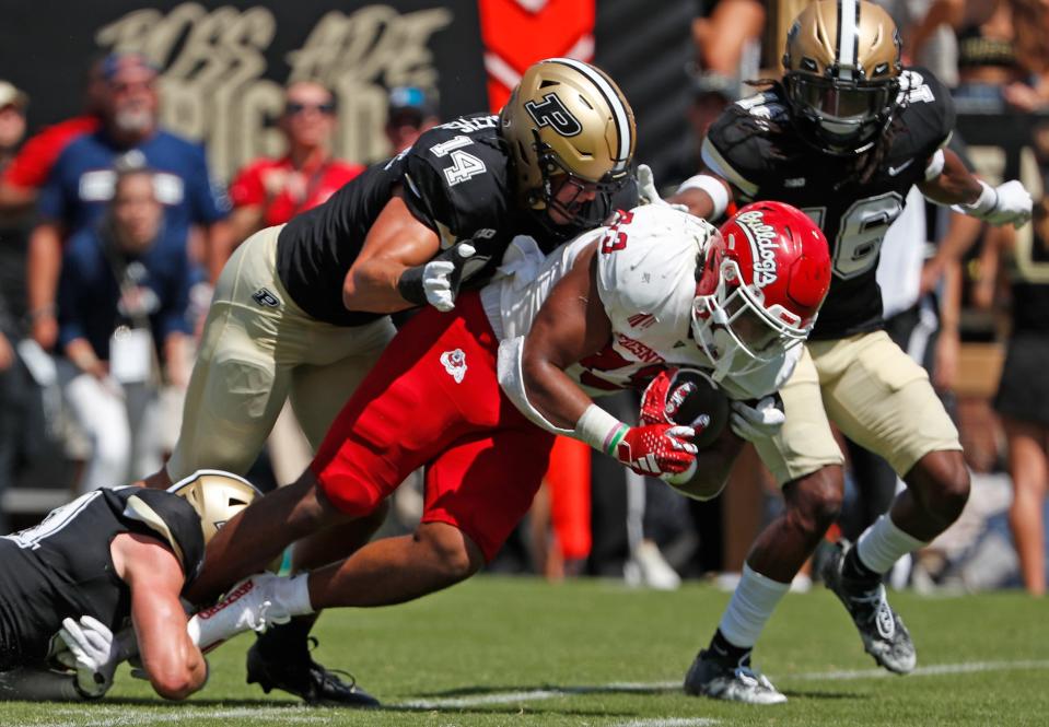 Fresno State Bulldogs running back Elijah Gilliam (33) is tackled by Purdue Boilermakers defensive back Dillon Thieneman (31), Purdue Boilermakers linebacker Yanni Karlaftis (14) and Purdue Boilermakers defensive back Marquis Wilson (16) during the NCAA football game, Saturday, Sept. 2, 2023, at Ross-Ade Stadium in West Lafayette, Ind. Fresno State Bulldogs won 39-35.