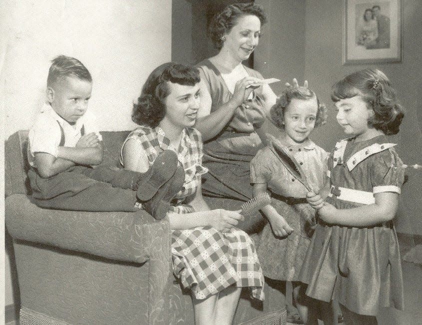 Akron's triplet cousins, all 5, get ready for their first day of kindergarten in 1953. Richard Leonard Jr. sits and pouts as, left to right, his aunts Mary Campanale and Delia Antonino fuss over daughters Phyllis Antonino and Marie Campanale.