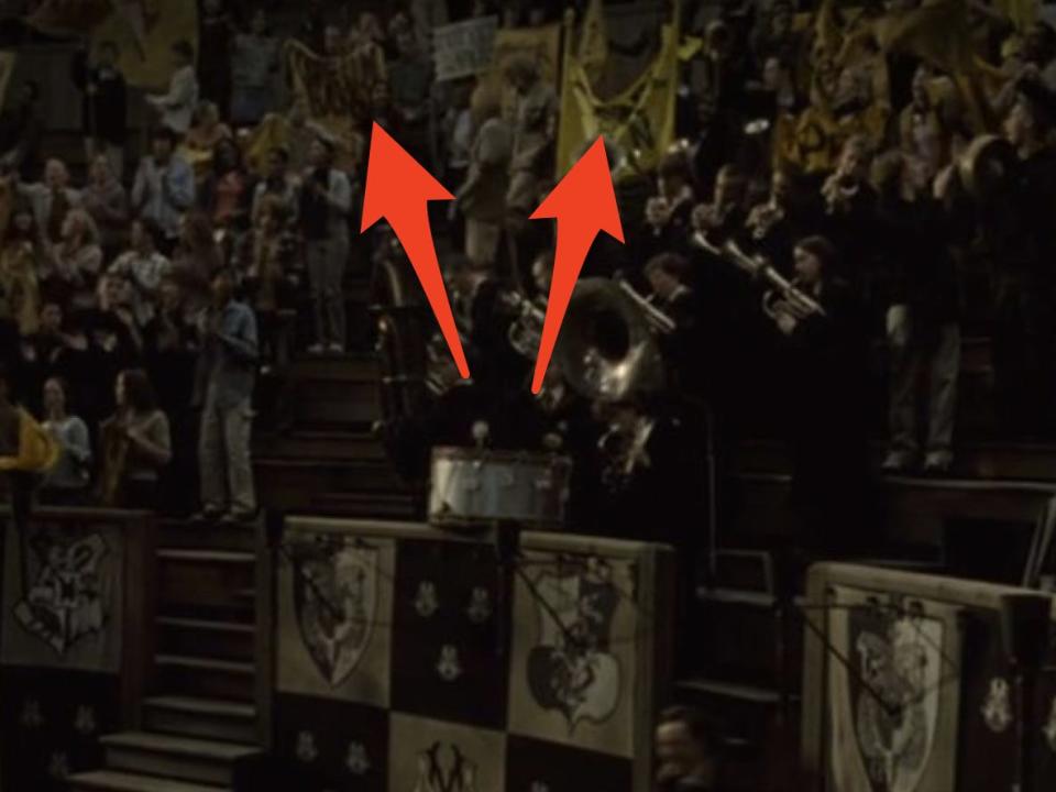 arrows pointing to yellow banners in the crowd at the triwizard tournement in goblet of fire
