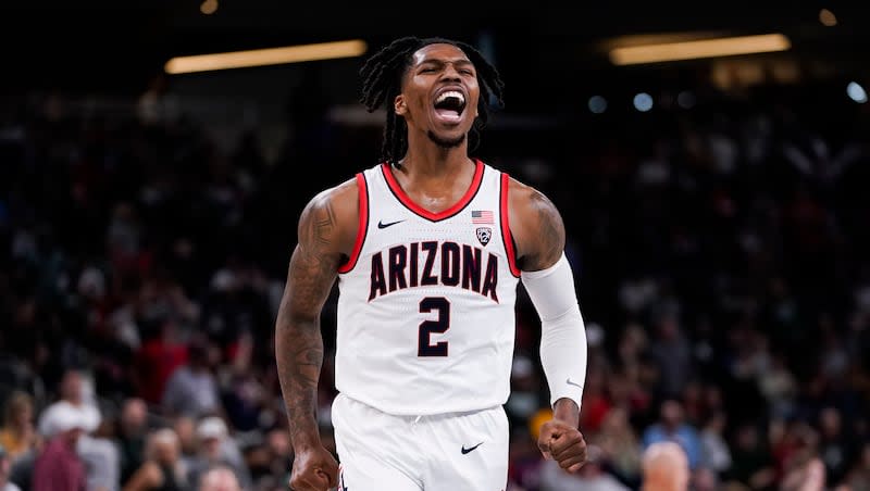 Arizona guard Caleb Love reacts after making a buzzer-beater 3-point basket to end the first half of an NCAA college basketball game against Michigan State, Thursday, Nov. 23, 2023, in Palm Desert, Calif. (AP Photo/Ryan Sun)