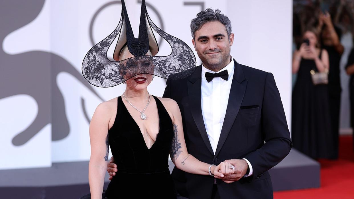 Lady Gaga flashes engagement ring on red carpet with fiance.