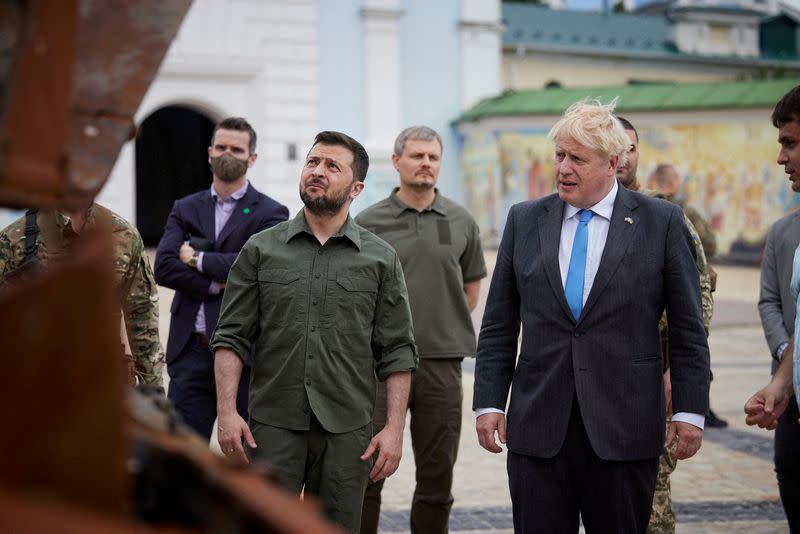 FILE PHOTO: British Prime Minister Boris Johnson and Ukraine's President Volodymyr Zelenskiy visit an exhibition of destroyed Russian military vehicles and weapons, in Kyiv