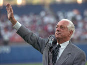 Retired Los Angeles Dodgers manager Tommy Lasorda waves to the fans as he gives his farewell speech Tuesday, July 30, 1996, at Dodger Stadium in Los Angeles. Lasorda retired after managing the Dodgers for nearly two decades. (AP Photo/Nick Ut)