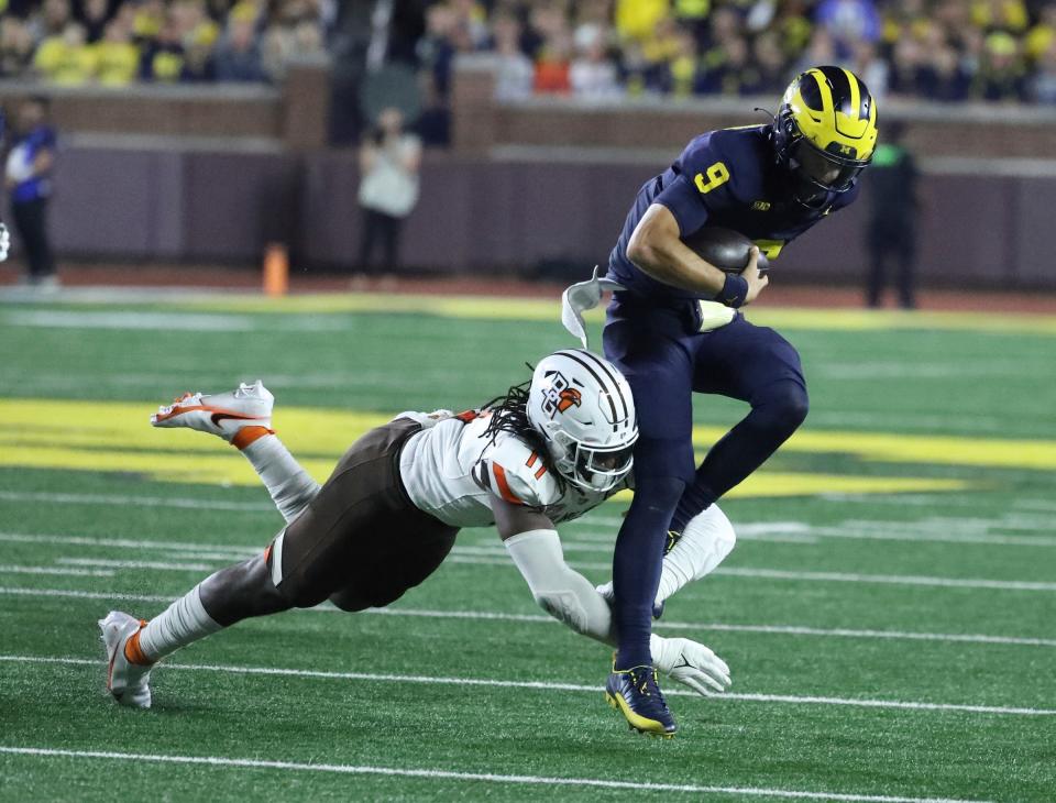 Michigan Wolverines quarterback J.J. McCarthy (9) is pressured by Bowling Green Falcons linebacker Demetrius Hardamon (11) during second half action Saturday, Sept.16 2023.