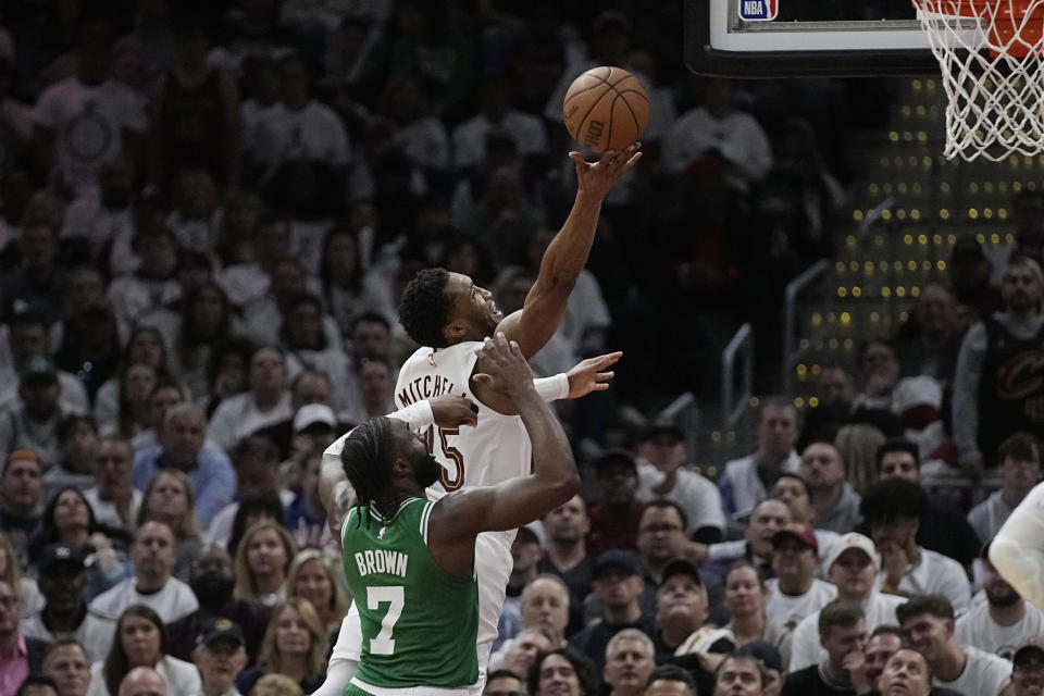 Cleveland Cavaliers guard Donovan Mitchell, rear, shoots in front of Boston Celtics guard Jaylen Brown (7) during the second half of Game 3 of an NBA basketball second-round playoff series Saturday, May 11, 2024, in Cleveland. (AP Photo/Sue Ogrocki)
