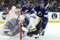 St. Louis Blues defenseman Robert Bortuzzo (41) goes down after crashing into Tampa Bay Lightning goaltender Andrei Vasilevskiy (88) during the first period of an NHL hockey game Friday, Nov. 25, 2022, in Tampa, Fla. Lightning defenseman Cal Foote (52) chases the play. AP Photo/Chris O'Meara)