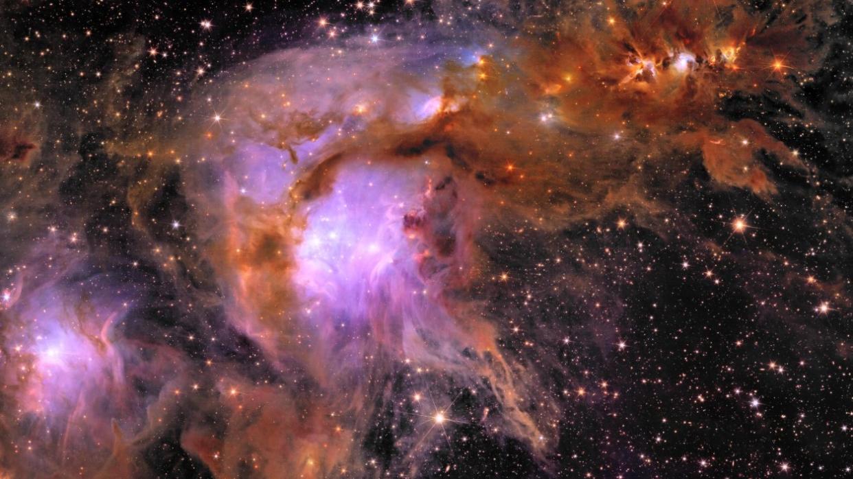  A stunning, billowing cloud of purple and orange gas in space. 