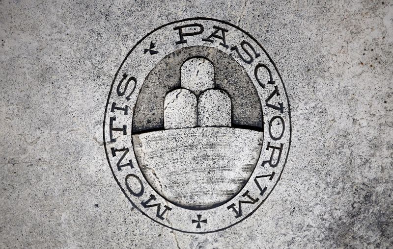 FILE PHOTO: FILE PHOTO: A logo of Monte dei Paschi di Siena bank is seen on the ground in downtown Siena