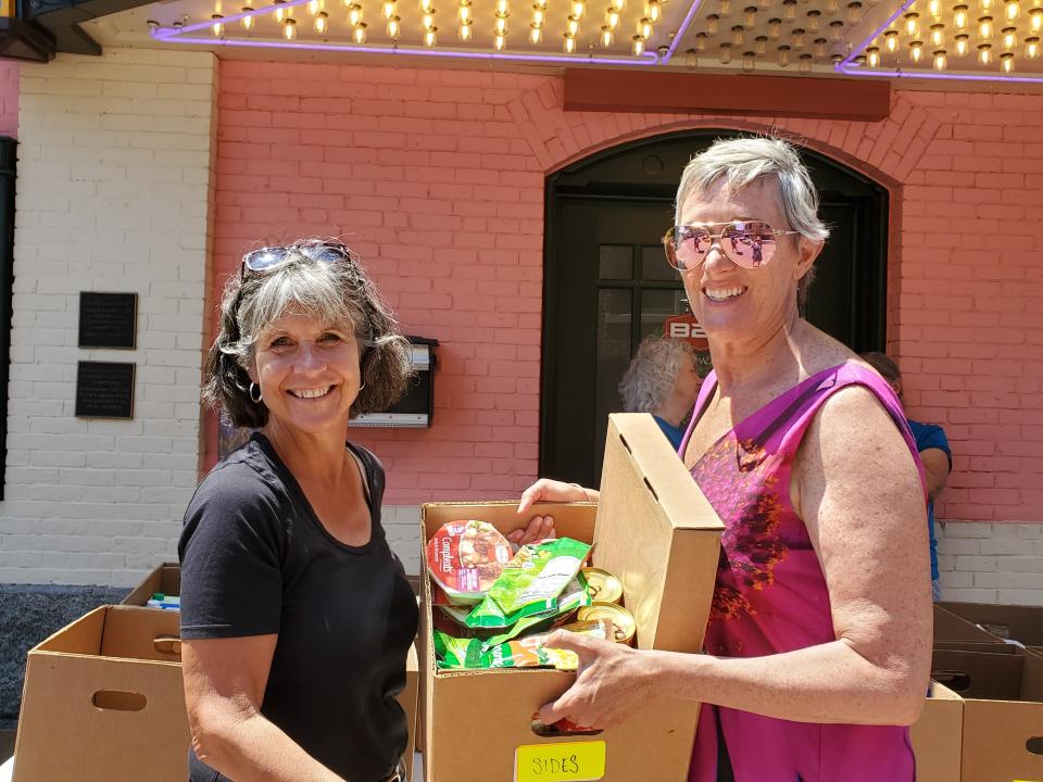 Deb Anthony and Denise Wheeler take in donations at the Fill the Hall event at The Music Hall in Portsmouth Sunday, June 26, 2022.