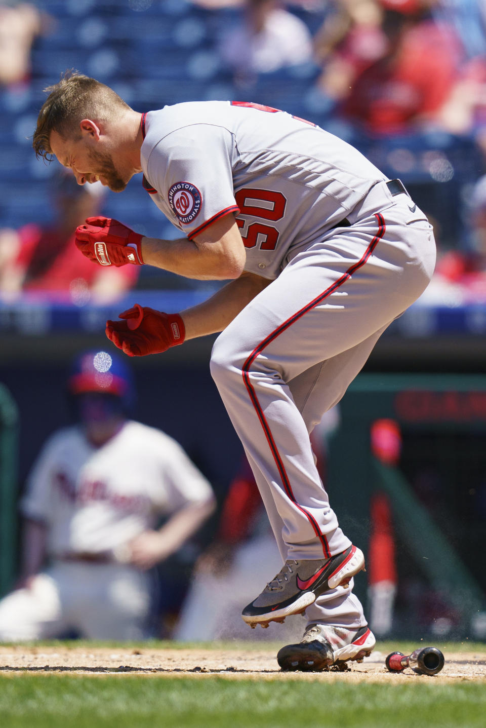 Washington Nationals' Austin Voth reacts after getting hit in the face by a pitch during the third inning of a baseball game against the Philadelphia Phillies, Sunday, June 6, 2021, in Philadelphia. (AP Photo/Chris Szagola)