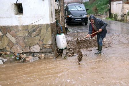 A local removes mud gathered outside his property during a heavy storm in the village of Fodele, on the island of Crete, Greece February 25, 2019. Picture taken February 25, 2019. REUTERS/Stefanos Rapanis