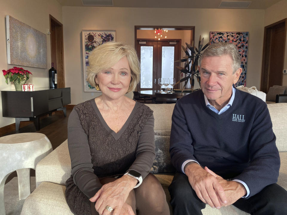 Kathryn and Craig Hall, owners of Hall Rutherford Winery, sit inside the winery where they held a “wine cave” fundraising dinner for Democratic presidential candidate, South Bend, Ind., Mayor, Pete Buttigieg, Friday, Dec. 20, 2019, in Rutherford, Calif. (AP Photo/Terence Chea)