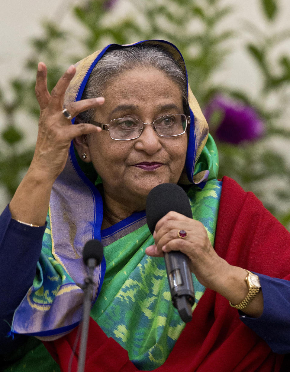 Bangladeshi Prime Minister Sheikh Hasina interacts with journalists in Dhaka, Bangladesh, Monday, Dec. 31, 2018. Bangladesh's ruling alliance won virtually every parliamentary seat in the country's general election, according to official results released Monday, giving Hasina a third straight term despite allegations of intimidation and the opposition disputing the outcome. (AP Photo/Anupam Nath)