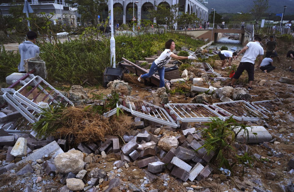 <p>People clean up debris caused by Typhoon Mangkhut outside a housing estate on the waterfront in Hong Kong, Monday, Sept. 17, 2018.<br>Hong Kong and southern China hunkered down as strong winds and heavy rain from Typhoon Mangkhut lash the densely populated coast. The biggest storm of the year left at least 28 dead from landslides and drownings as it sliced through the northern Philippines.<br>(Photo by Vincent Yu, AP) </p>