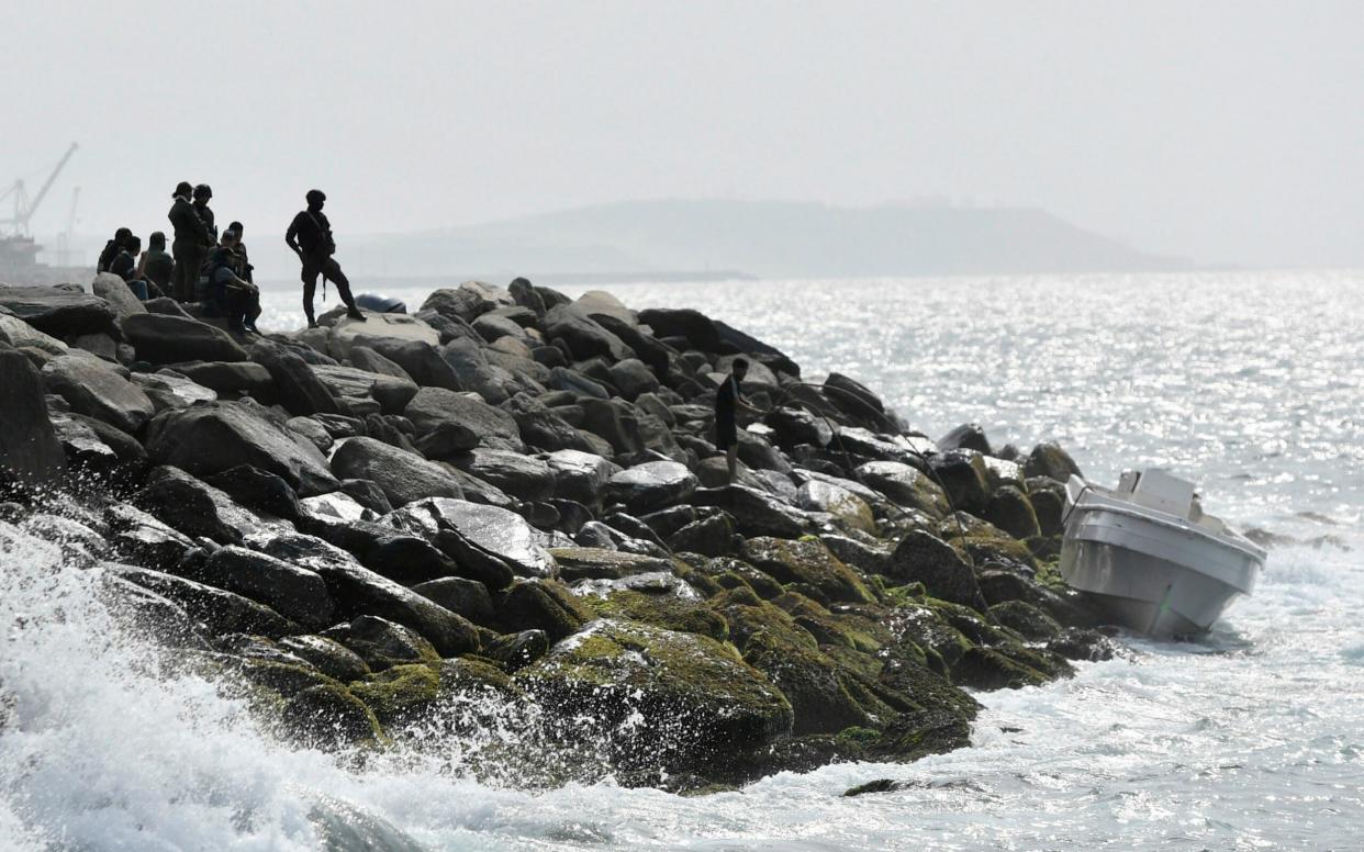 In this May 3, 2020 photo, security forces guard the shore area and a boat in which authorities claim a group of armed men landed - AP Photo/Matias Delacroix, File