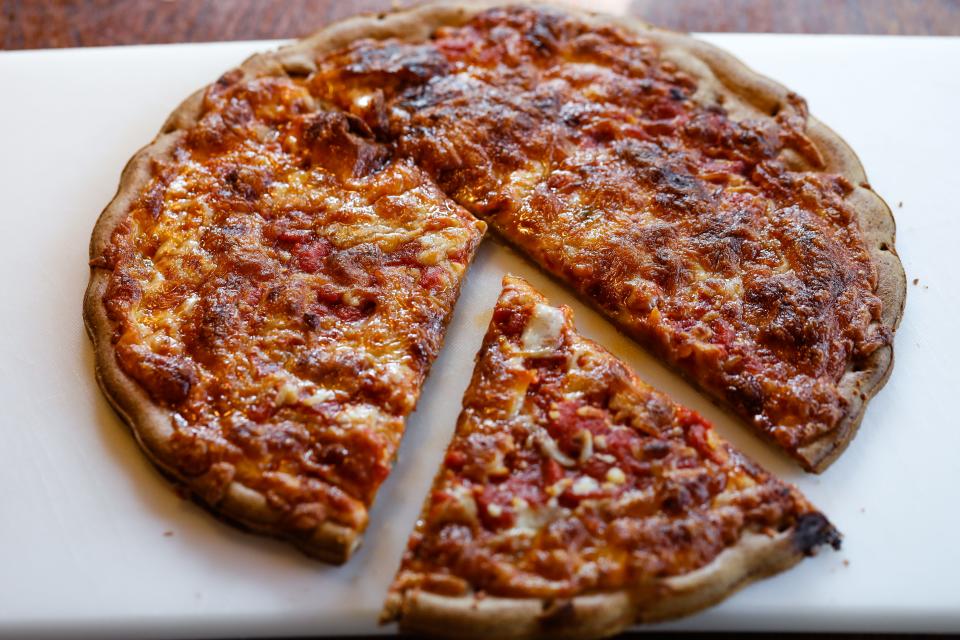 Capellos pizza with slice removed