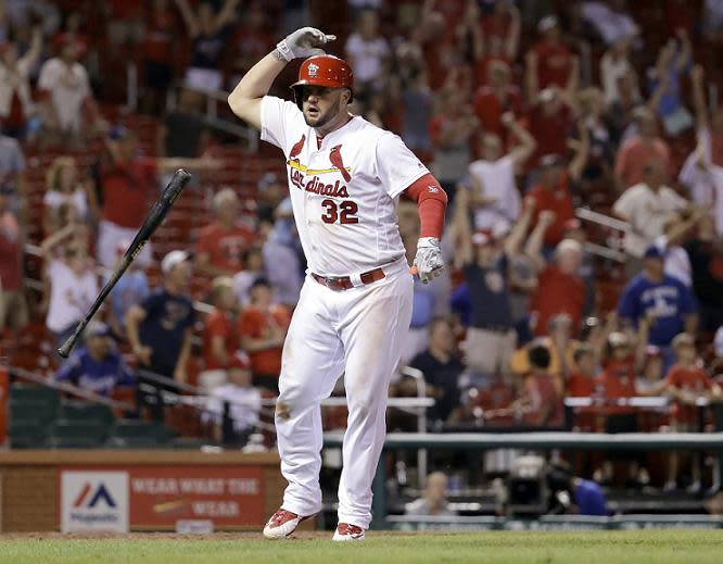 Matt Adams flips his bat in celebration after hitting a walk-off home run to defeat the Dodgers. (AP)