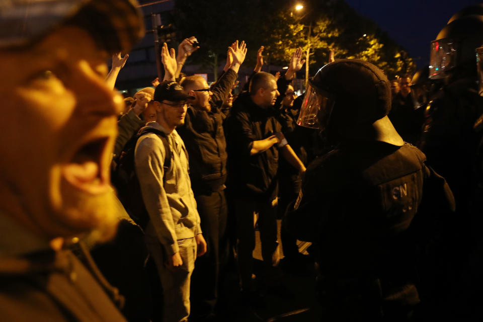 <p>Participants in a right-wing march confront riot police after police halted the march due to a blockade by counter-demonstrators on Sept. 1, 2018 in Chemnitz, Germany. Several thousand people had taken part in a march of silence organized by the right-wing Alternative for Germany (AfD) political party. Two refugees, a Syrian and an Iraqi, are accused of having stabbed Chemnitz local Daniel Hillig following an altercation in the early hours of August 26. The death has sparked angry protests by locals as well as right-wing groups that have led to clashes with police and counter-protesters. (Photo: Sean Gallup/Getty Images) </p>