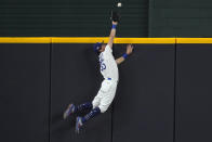 Los Angeles Dodgers' Cody Bellinger slams into the outfield wall and makes the catch as he robs San Diego Padres' Fernando Tatis Jr. of a home run on a deep drive during the seventh inning in Game 2 of a baseball National League Division Series Wednesday, Oct. 7, 2020, in Arlington, Texas. (AP Photo/Tony Gutierrez)