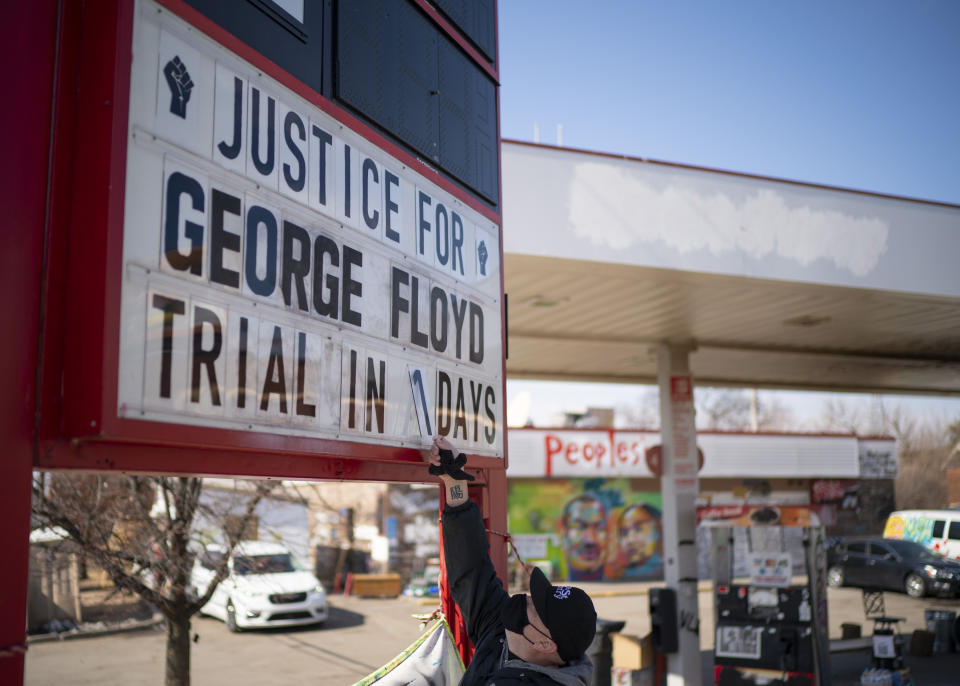 Billy Briggs, who lives just 170 steps from where George Floyd was killed, created and maintains the countdown sign at the gas station on the corner of George Floyd Square in Minneapolis, Minn. On Sunday, the eve of the trial date, he updated it to "1". (Jeff Wheeler /Star Tribune via AP)