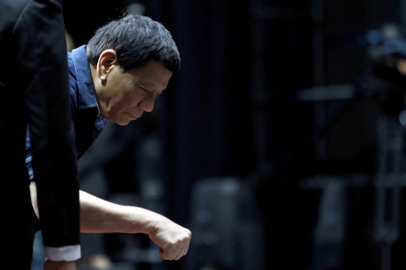 FILE PHOTO: Philippines President Rodrigo Duterte fist bumps a supporter at a community gathering event in Singapore