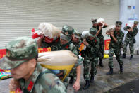<p>Frontier soldiers carry sand bags after typhoon Hato landed on Aug. 23, 2017 in Shenzhen, Guangzhou Province of China. (Photo: VCG via Getty Images) </p>