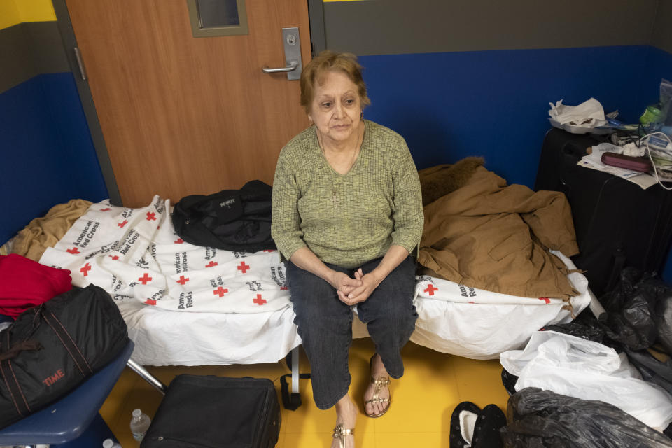 Dora Corso sits with all her belongings in the hallway of the North Myrtle Beach High School in North Myrtle Beach, S.C., Wednesday Sept. 4, 2019. Corso was evacuated from the beach front resort where she was living to the Red Cross shelter and has no plans for where to go after the storm passes. Residents of North Myrtle Beach are awaiting the arrival of Hurricane Dorian later today and through Thursday. (Jason Lee/The Sun News via AP)