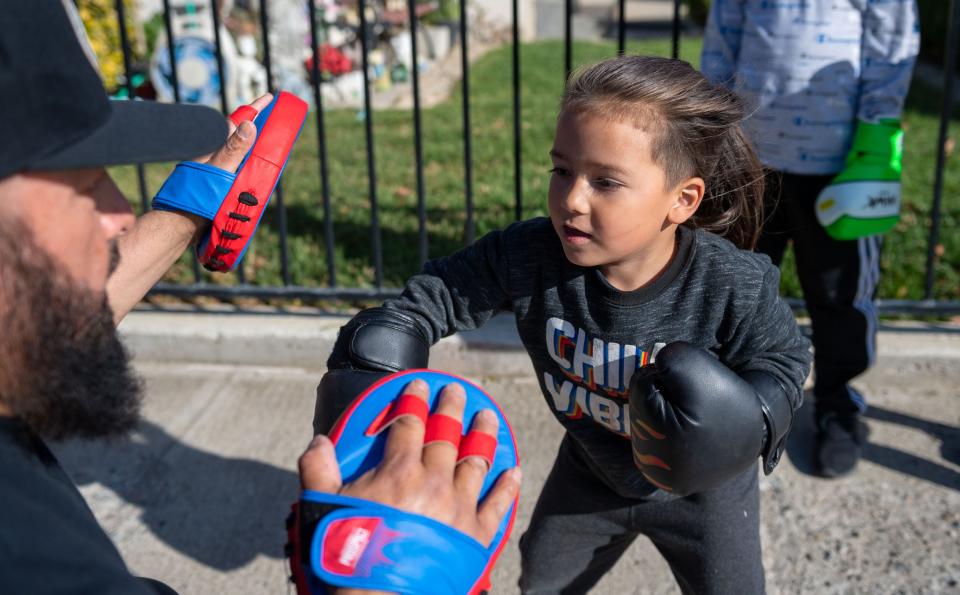 A young member of A.V.I.L.A Victory Boxing practices his jabs during a training session outside a home garage in Greenfield on May 4.