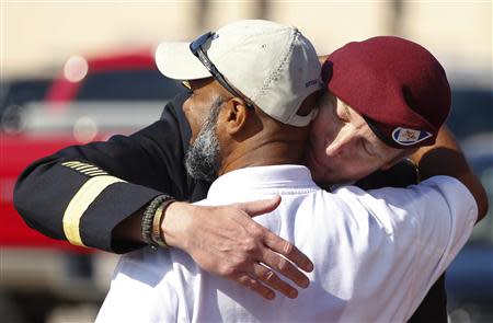 U.S. Army Brigadier General Jeffrey Sinclair shares a hug with his friend, retired command sergeant major Ian Toney after leaving the courthouse following sentencing in his court-martial case at Fort Bragg in Fayetteville, North Carolina March 20, 2014. REUTERS/Chris Keane