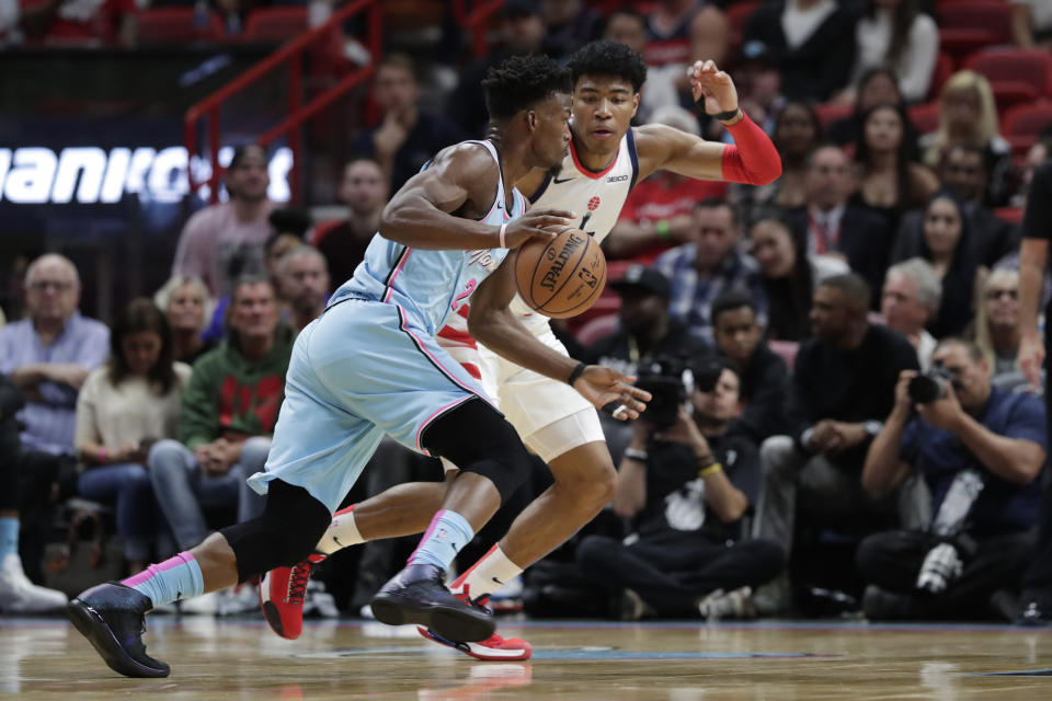 Miami Heat forward Jimmy Butler, left, drives to the basket as Washington Wizards forward Rui Hachimura defends during the first half of an NBA basketball game, Friday, Dec. 6, 2019, in Miami. (AP Photo/Lynne Sladky)