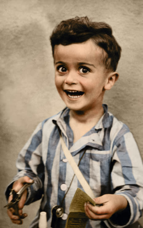 POLAND: Istvan Reiner, aged 4, smiles for a studio portrait, shortly before being murdered at Auschwitz concentration camp. The photo was donated to the United States Holocaust Memorial Museum by Istvan's half-brother Janos (John) Kovacs.  HARROWING colourised images of the Holocaust which expose the full terrors faced by the death camp?s inmates have emerged SEVENTY-FIVE-YEARS after the liberation of Auschwitz, the largest Nazi death camp. Sobering photos, some revamped in colour for the first time, capture the horror of genocide in the eyes of a gaunt 18-year-old Russian woman; a concentration camp responsible for the deaths of tens of thousands of innocent people being ceremonially burnt to the ground by liberating British forces; and malnourished Jewish children peering out at their Soviet rescuers through a barbed wire fence at Auschwitz. Other upsetting colourisations include a smiling portrait of four-year-old, Istvan Reiner, taken just a few weeks before he was murdered at the infamous death camp, and another showing a palpably relieved young Jewish refuge recuperating in hospital after being rescued by appalled Allied Forces. Mediadrumimages/TomMarshall(PhotograFix)2020