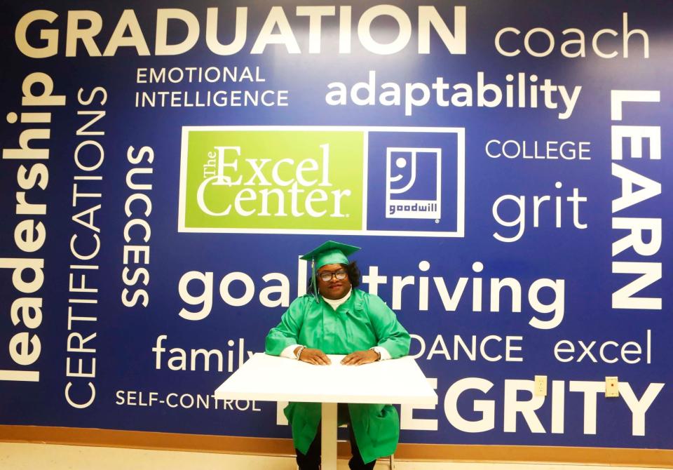 Recent graduate, Sandra Wicks, poses in front of a mural inside of The Excel Center, on Monday, November 21, 2023 located at 2576 Thousands Oaks in Memphis, Tenn.