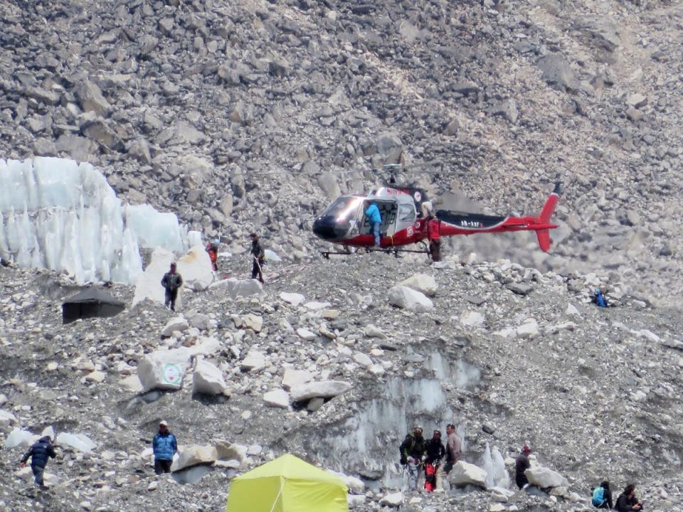 A Nepalese rescue helicopter lands at Everest Base Camp during rescue efforts following an avalanche that killed sixteen Nepalese sherpas in the  Khumbu icefall at the base of Mount Everest in 2014 (AFP via Getty Images)