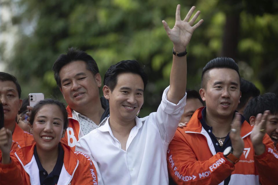 Pita Limjaroenrat, center, (white shirt) leader of Move Forward Party, waves to his supporters, in Bangkok, Monday, May 15, 2023. Fresh off a stunning election victory in which they together captured a majority of seats in the House of Representatives, Thailand's top two opposition parties began planning Monday for the next stage in their bid to replace the military-dominated government. (AP Photo/Wason Wanichakorn)