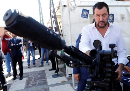 FILE PHOTO: Italian Interior Minister Salvini stands next to a sniper rifle during a visit to celebrate the anniversary of the Central Security Operations Service (NOCS), a SWAT team of the Polizia di Stato in Rome