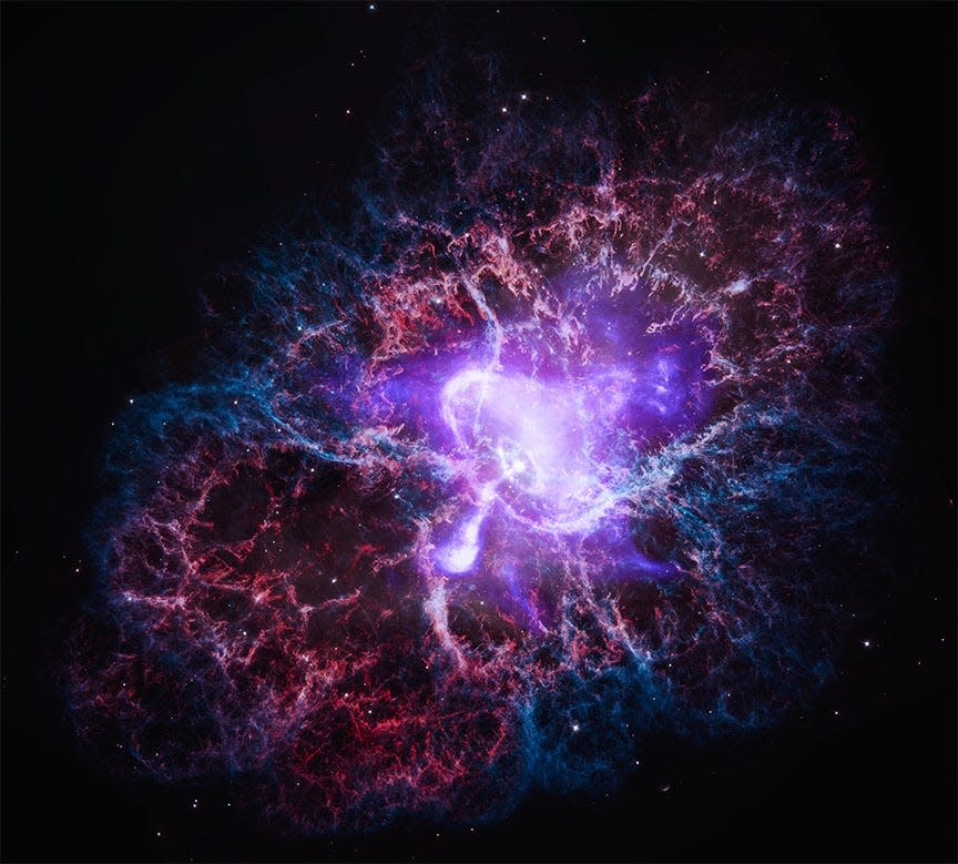crab nebula expanding structured clouds of purple red and blue with a bright purple point in the center with a bright jet shooting out it and bright concentric circles around it