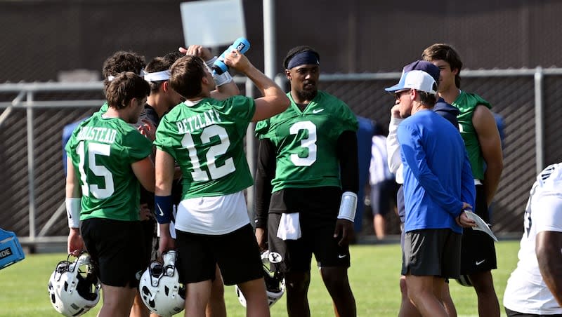 The quarterback huddle with coach Aaron Roderick and others as BYU completes their first fall football practice in Provo on Wednesday, July 31, 2024.