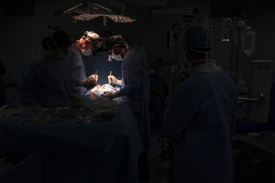 Dr. Vitaly Dedovich, center left, of the Novick Cardiac Alliance medical team performs open heart surgery on Yazan, 1, at the Tajoura National Heart Center in Tripoli, Libya, on Feb. 27, 2020. The team was the best, and perhaps last, hope for Yazan. But that meant his family had to travel to the most dangerous place in the war-ravaged country — the capital Tripoli, where the Tajoura National Heart Center is located. (AP Photo/Felipe Dana)