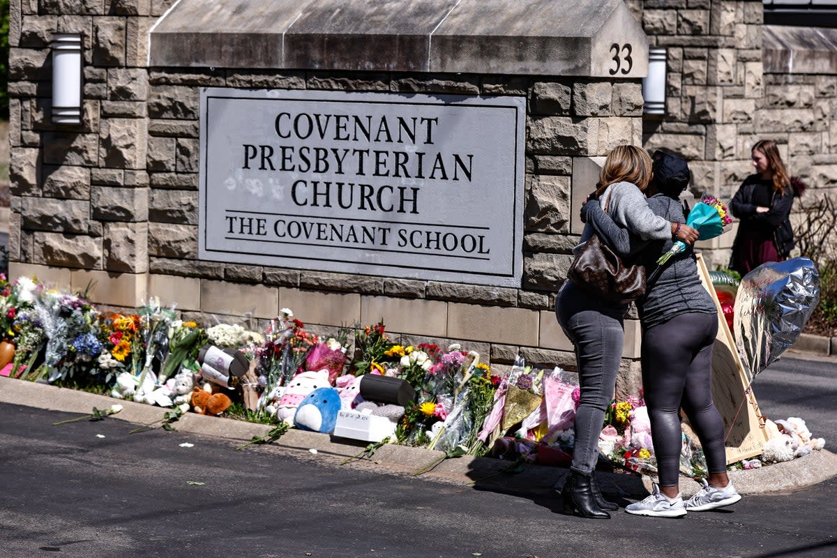 Two women hug near a memorial at the entrance to The Covenant School, March 29, 2023, in Nashville, Tennessee (Copyright 2023)
