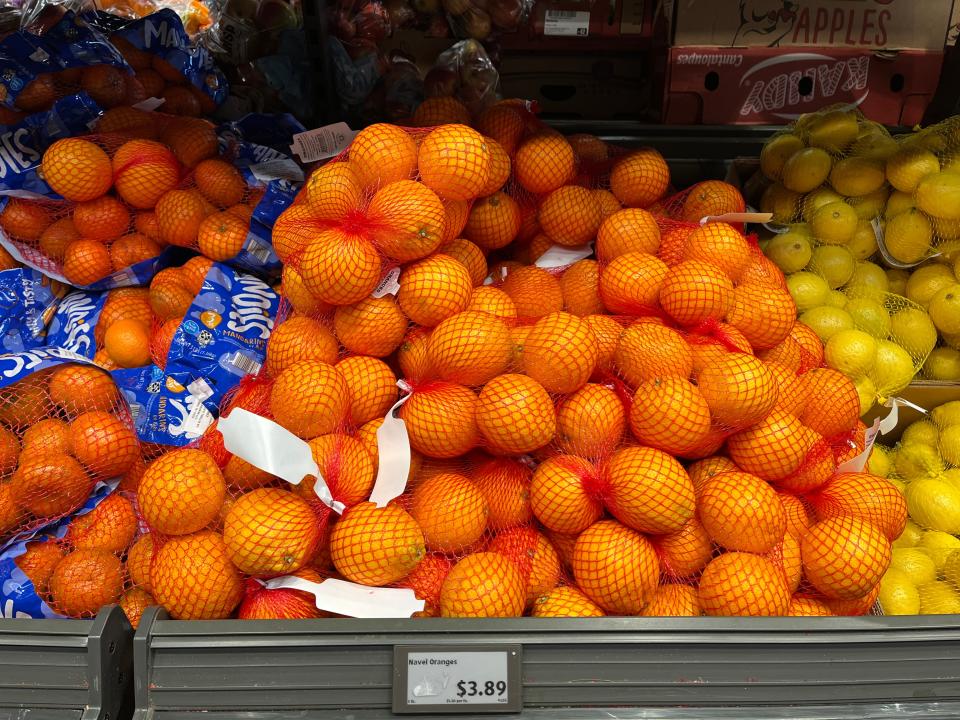 bags of navel oranges next to cuties and lemons in the produce section at aldi