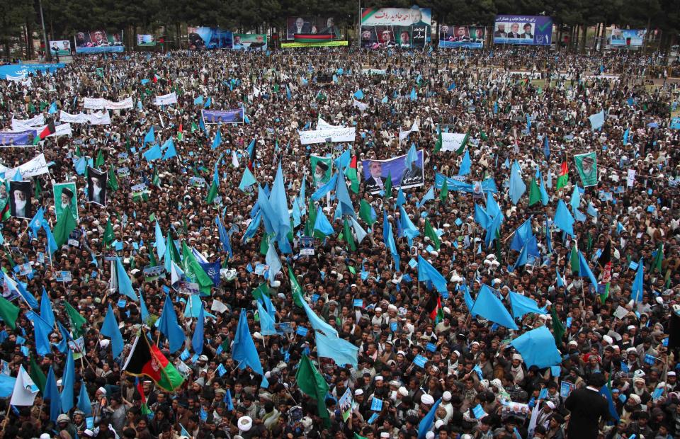 Supporters of Afghan presidential candidate Abdullah Abdullah listen to his speech during a campaign rally in Herat, Afghanistan, Tuesday, April 1, 2014. Eight Afghan presidential candidates are campaigning for the third presidential election. Elections will take place on April 5, 2014. (AP Photo/Hoshang Hashimi)