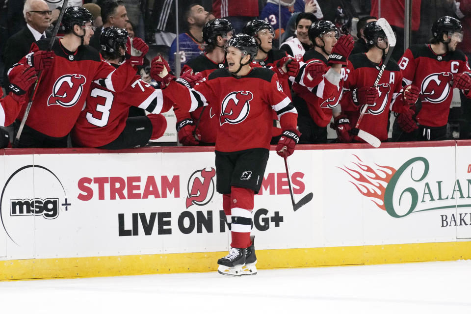 New Jersey Devils' Curtis Lazar celebrates the winning goal with teammates during the third period of an NHL hockey game against the New York Islanders in Newark, N.J., Tuesday, Nov. 28, 2023. The Devils defeated the Islanders 5-4. (AP Photo/Seth Wenig)