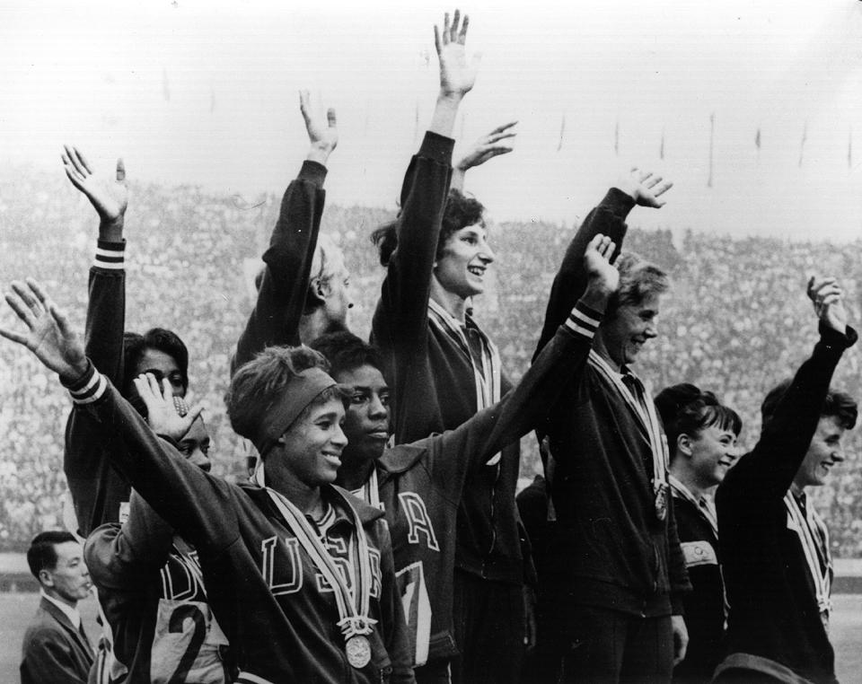 <p>The Polish winners of the women's 4x100 Meters Relay Race celebrate at the top of the podium, while the second-place American team and third-place British team wave to fans as well. </p>