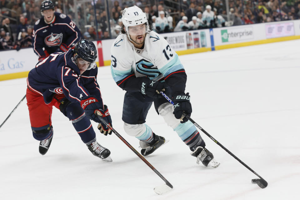 Seattle Kraken's Brandon Tanev, right, tries to shoot past Columbus Blue Jackets' Tim Berni during the first period of an NHL hockey game Friday, March 3, 2023, in Columbus, Ohio. (AP Photo/Jay LaPrete)