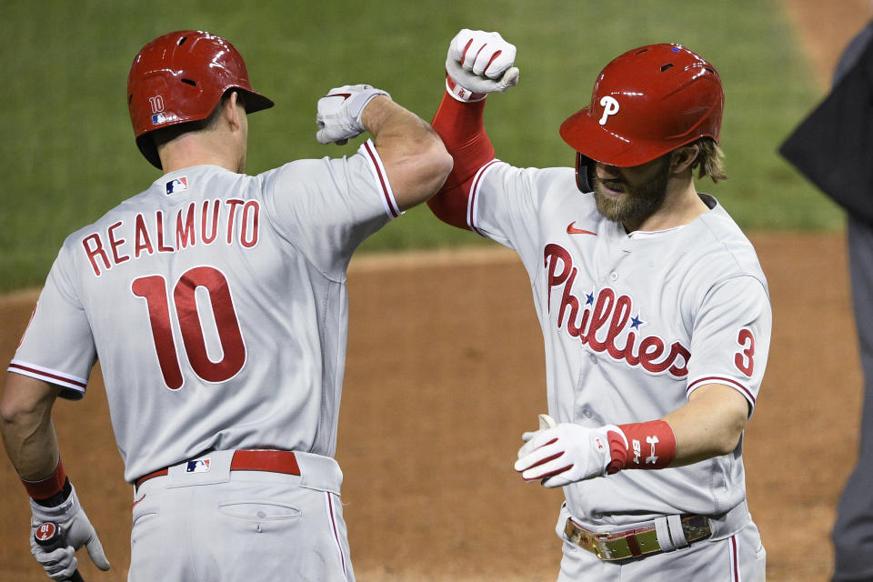 Philadelphia Phillies' Bryce Harper (3) celebrates his home run with J.T. Realmuto (10) during the sixth inning of the team's baseball game against the Washington Nationals, Wednesday, Sept. 23, 2020, in Washington. This was Harper's second homer of the night. (AP Photo/Nick Wass)