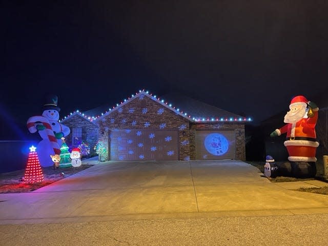 Located at 2617 W. Colton Ave. in Ozark, Jennifer Henderson's Christmas decoration display is fit with two large inflatables: a snowman and Santa Claus. Smaller inflatables and a lit Christmas tree decorate the yard. The front of the house is lit by LED-projector snowflakes.