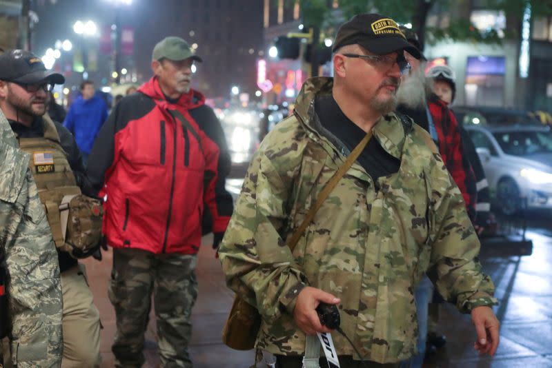 FILE PHOTO: Stewart Rhodes of the Oath Keepers holds a radio as he departs a Trump rally in Minneapolis